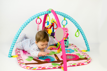 cute baby girld playing in an activity gymの写真素材