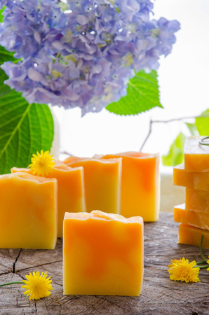 homemade orange and dandelion herbal natural soap using olive oil shea and cocoa butterの写真素材