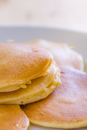 beautiful prepare pancakes for serving process.pancakes made from dough and batter.tasty dessert sweets pancakes served on daylight in cafe background.pancakes on black and white plate.の写真素材
