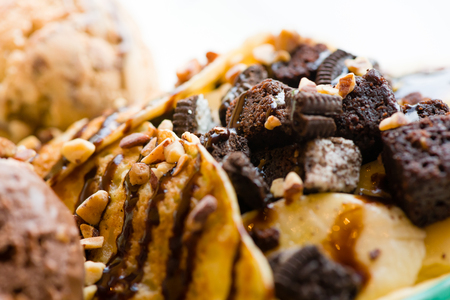 tasty pancakes with chocolate ice cream crispy waffle whipped cream with brownies cherry almond and chocolat syrup on top.served pancakes crepes on plate.sweets dessert brownies pancakes crepes.の写真素材