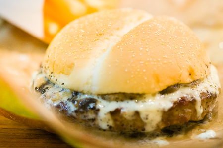 american beef hamburger with cheese and french fries at beautiful fast food and cafe bistro.delicious low price hamburger in budget.close up details of hamburger and chicken nuggets at fast food.の写真素材