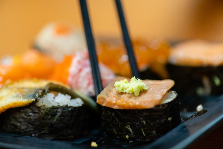 traditional japanese local food sushi.delicious seafood sushi with wasabi and seaweed on black plate.japanese chef cook sushi for customer at japanese restaurant and cafe.sushi with wasabi.の写真素材