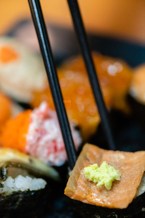 traditional japanese local food sushi.delicious seafood sushi with wasabi and seaweed on black plate.japanese chef cook sushi for customer at japanese restaurant and cafe.sushi with wasabi.の写真素材