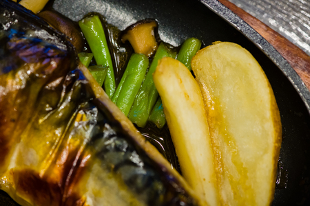 delicious japan food style menu.traditional japanese local food Saba grilled with teriyaki sauce on hot pan.japanese chef cooking at japanese restaurant and cafe.tasty japanese food on hot pan.の写真素材