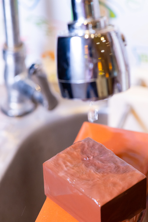 woman professional chef hands hold knife for whetting on whetstone.premium professional stone from japan.knife sharpening process with traditional sharpener stone for knife sharpen edge in restaurant.の写真素材