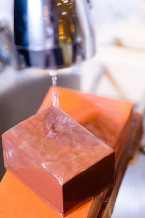 woman professional chef hands hold knife for whetting on whetstone.premium professional stone from japan.knife sharpening process with traditional sharpener stone for knife sharpen edge in restaurant.の写真素材