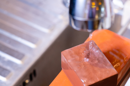 woman professional chef hands hold knife for whetting on whetstone.premium professional stone from japan.knife sharpening process with traditional sharpener stone for knife sharpen edge in restaurant.の写真素材