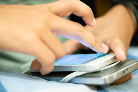 people surfing and browsing the web on smart phone.people enjoy with game in social media network on smart phone.portable power bank for charging mobile devices.の写真素材