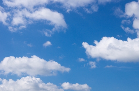 white fluffy clouds in the blue skyの写真素材