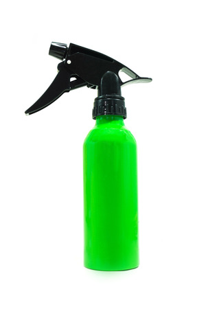 green plastic spray bottle isolated on whiteの写真素材