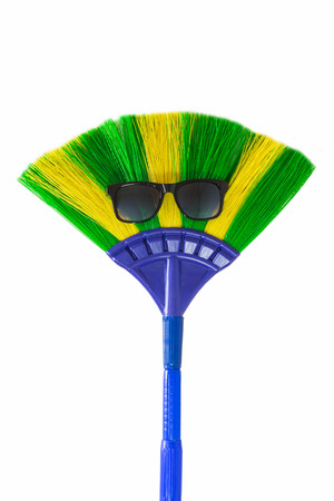 broom wearing sunglasses isolated on whiteの写真素材