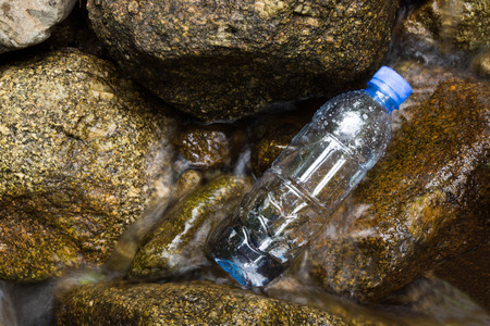 Fresh bottles water in a waterfallの写真素材