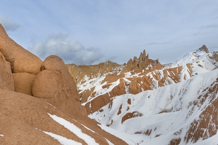 Orange hills in the snow, Kyrgyzstan, witerの写真素材