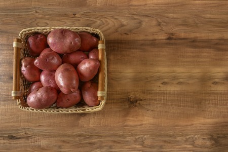 Raw potato. Fresh potatoes on wooden background. Free place for text.の写真素材