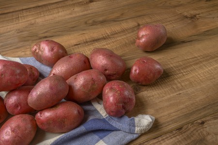 Raw potato. Fresh potatoes on wooden background. Free place for text.の写真素材