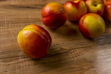 Fresh ripe peaches on a wooden tableの写真素材