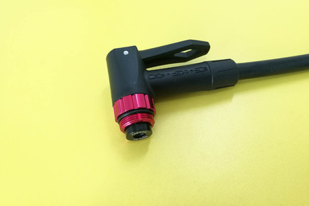 Closeup of a Air compressor bicycle pump mount isolated on yellow background,の写真素材
