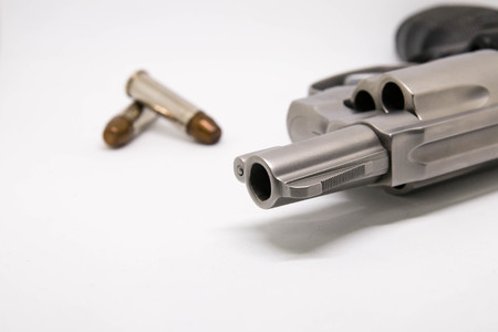 close-up a handgun with bullets isolated on white backgroundの写真素材