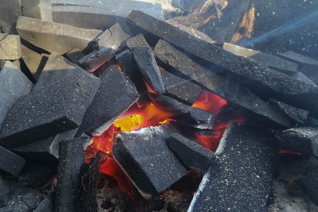 Burning coals close-up for cooking and a background.