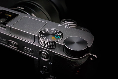 Control dial on a DSLR camera, mirrorless,  close up image isolated on black backgroundの写真素材