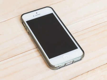Phone on wood table backgroundの写真素材