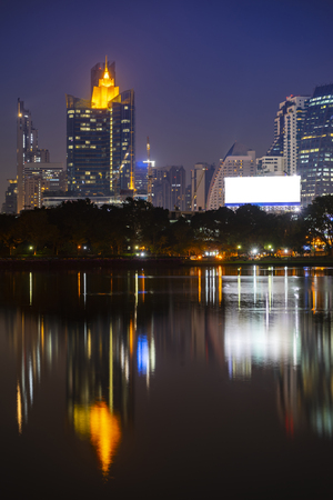 Building city in business area night scene with river reflection in Bangkok, Thailand.の写真素材