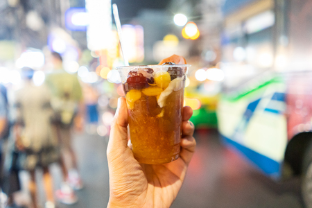 Modern chinese dessert on hand holding with copy space at China town blurry background, Bangkok Thailand.の写真素材