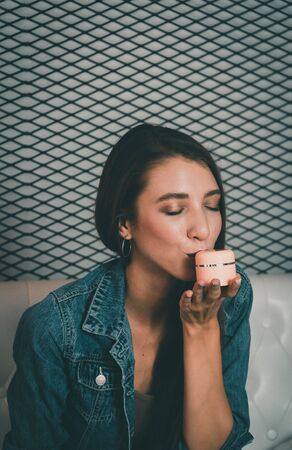 Young beauty blogger selling her cosmetic on live stream broadcasting by mobile phone.