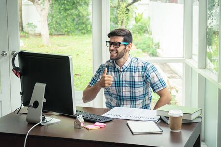 Casual young caucasian businessman at his desk in winning concept.の写真素材