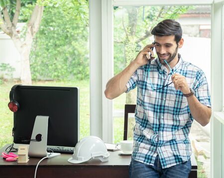 Casual man talking business with mobile phone.の写真素材