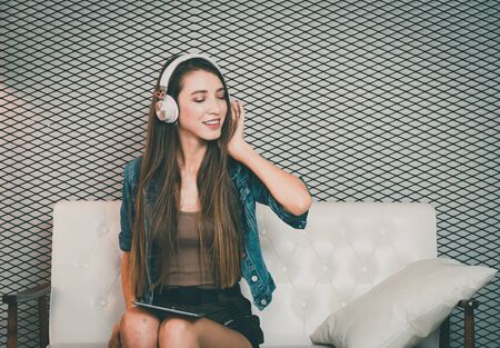 Young beautiful girl enjoy music.の写真素材