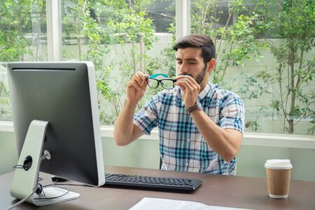 Good looking young business man working on the internet at homeの写真素材