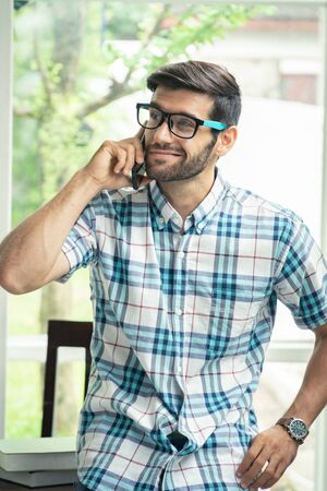 Casual man talking business with mobile phone.の写真素材