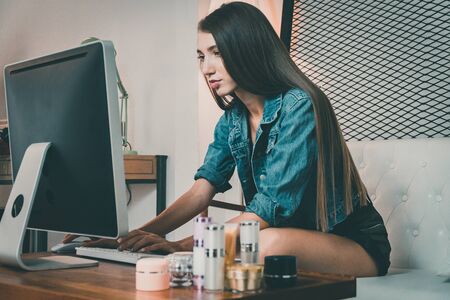 Casual woman working on her computer  at home.の写真素材
