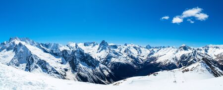 Caucasus mountains - The highest mountains in Russia. Snow mountains with blue sky background. Panoramaの写真素材