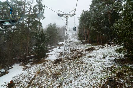 Ski cable car in the winter snow season. cloudy sky background.の写真素材