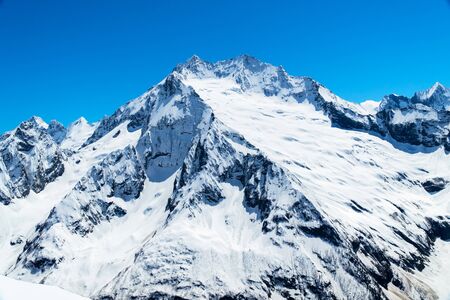 Caucasus mountains - The highest mountains in Russia. Snow mountains with the blue sky backgroundの写真素材