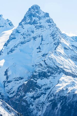 Caucasus mountains - The highest mountains in Russia. Snow mountains with a blue sky backgroundの写真素材