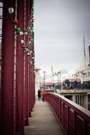 Walking on red bridge nearby the yacth dock -の写真素材