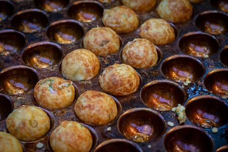 Takoyaki - The traditional Japanese food at Kuromon Market, the most famous market in Osaka, Japan.の写真素材