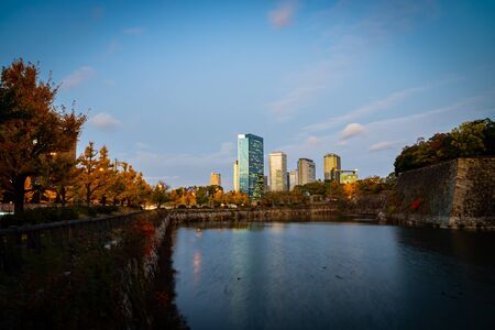 Landscape of Osaka downtown buildings nearby the Osaka Castle at dusk in the evening - Osaka city, Japan.の写真素材