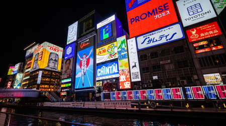 OSAKA, JAPAN - NOVEMBER 27, 2019 : Dotonbori walking street in the night with the most famous neon light banner Glico runner in Osaka city, Japan.のeditorial素材