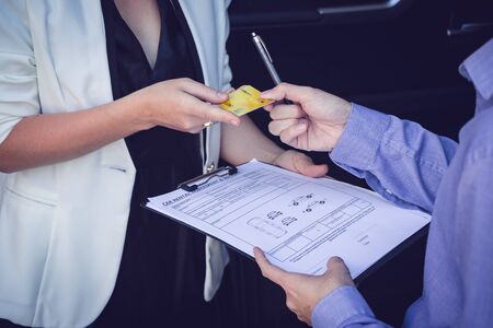 Asian couple buying a new car with credit card. Film tone effected. Close-upの写真素材