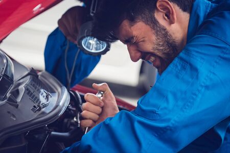 Mechanics checking and repairing the car. Car auto services conceptsの写真素材