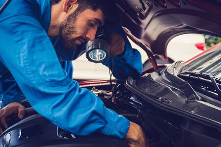 Mechanics checking and repairing the car. Car auto services conceptsの写真素材