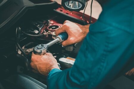 Mechanics checking and repairing the car. Car auto services conceptsの写真素材