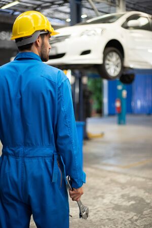 Mechanics holding wrench in the workshop garage. Auto car services conceptsの写真素材