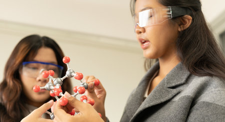 STEM education concept. Asian children in laboratory research an experiment exam with molecule...