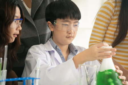 STEM education concept. Asian children in laboratory research an experiment exam with chemistry beaker. The new education system in a classroom including Science, Technology, Engineering and Mathematics.の写真素材