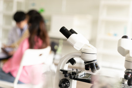STEM education concept. Asian children in laboratory research an experiment exam with microscope. The new education system in a classroom including Science, Technology, Engineering and Mathematics.の写真素材